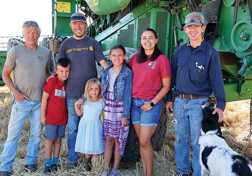 Andrew and Jessica Schafer are the fourth generation to farm Windy Acres Farms, which was established in the 1940s in Franklin County. Pictured, from left, are Jeff Habberstad, Aiden Schafer (7), Andrew Schafer, Sloan Schafer (4), Riley Schafer (9), Jessica Schafer, Paul MacDuff, and harvest dog, Lee.